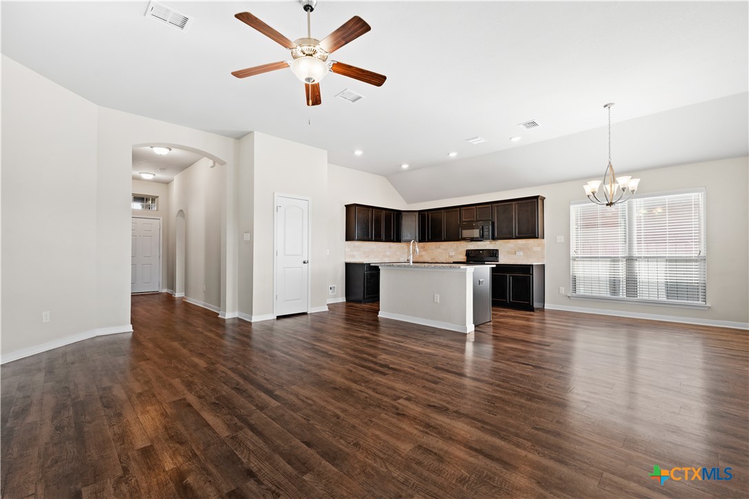 4124 Riata Ranch Road Waco, TX 76705 - Photo 5 of 26 a view of empty room with wooden floor and window