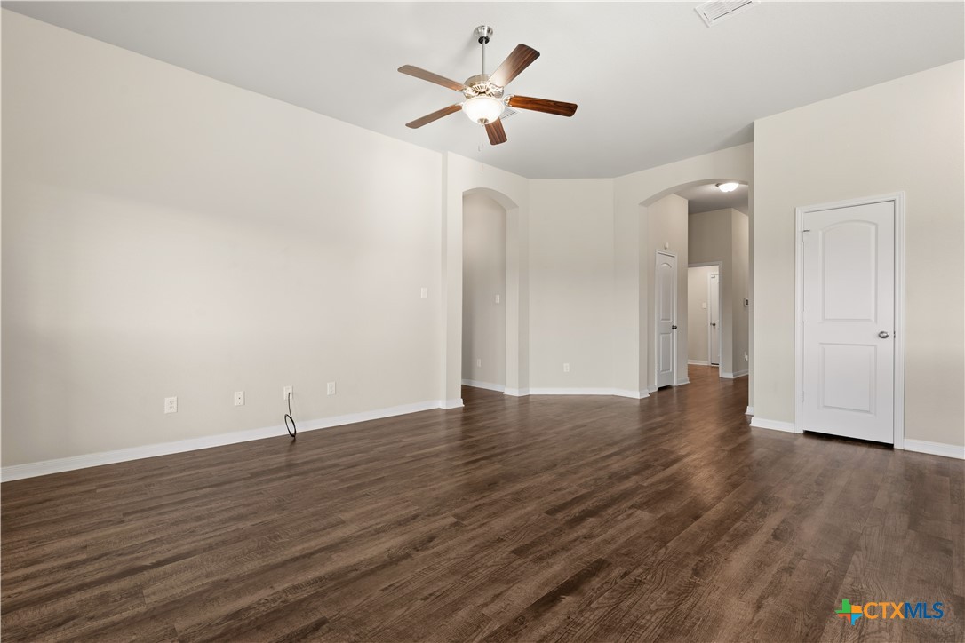 4124 Riata Ranch Road Waco, TX 76705 - Photo 9 of 26 a view of an empty room with wooden floor