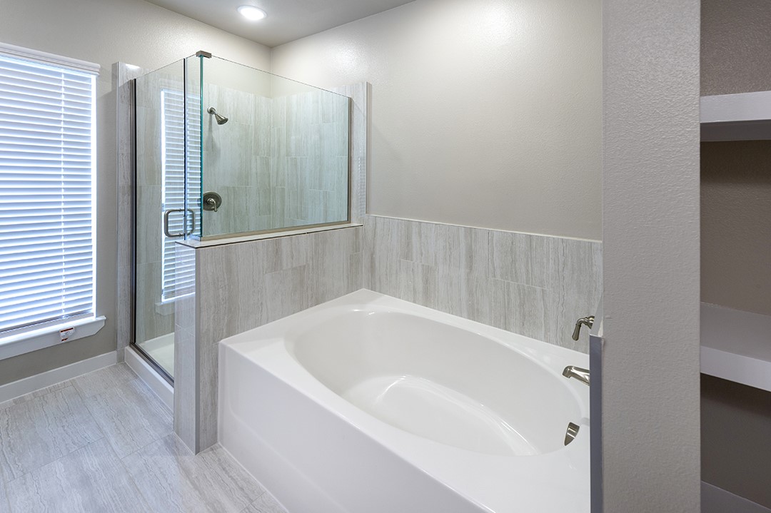 1724 Partnership Way, Unit 3101 Katy, TX 77449 - Photo 26 of 30 a white bath tub sitting in a bathroom and shower