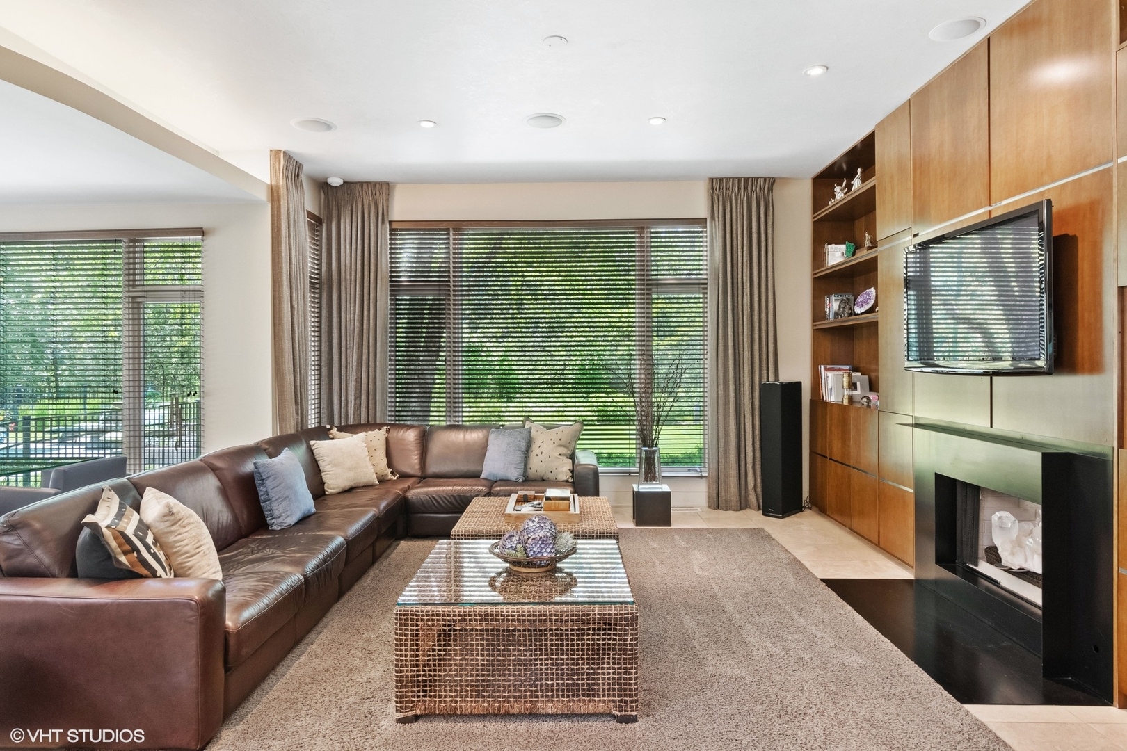 1632 Saunders Road Riverwoods, IL 60015 - Photo 12 of 38 a living room with furniture floor to ceiling window and a fireplace