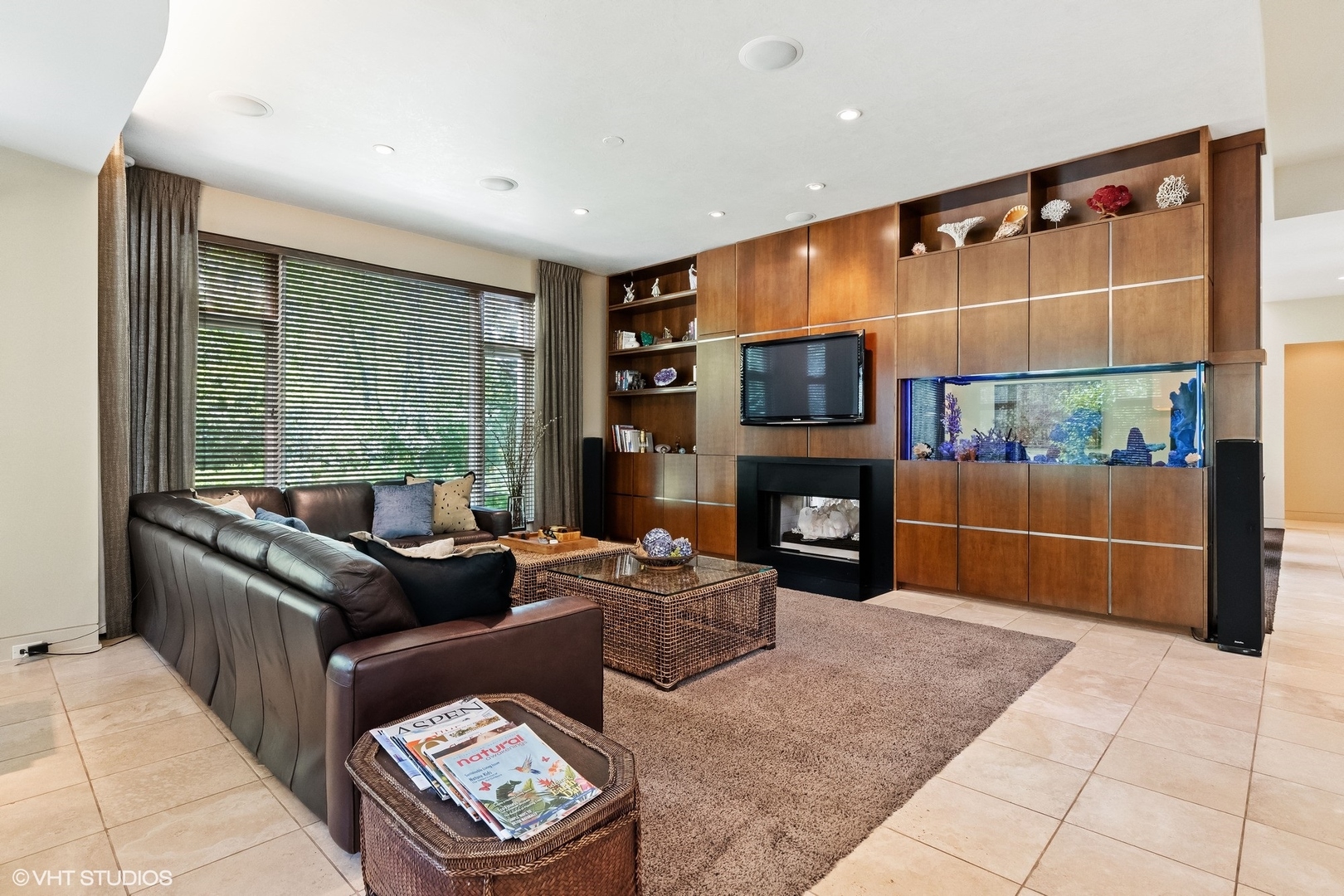 1632 Saunders Road Riverwoods, IL 60015 - Photo 13 of 38 a living room with furniture a fireplace and a flat screen tv
