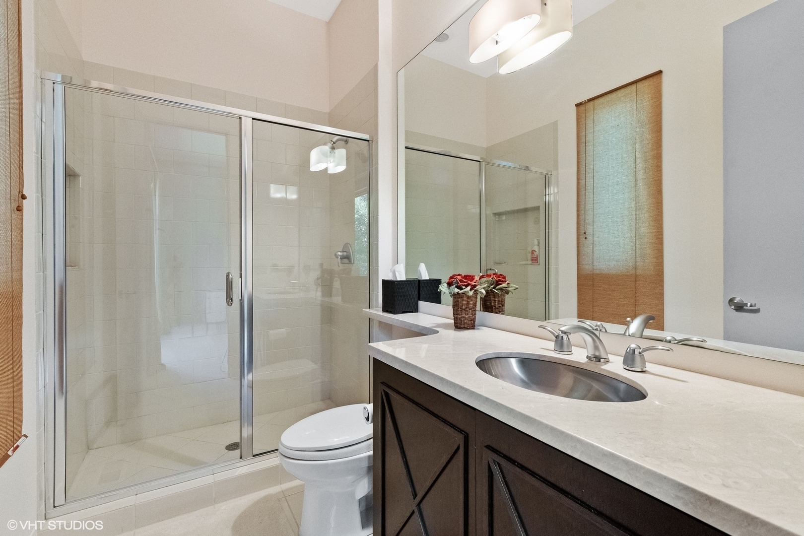 1632 Saunders Road Riverwoods, IL 60015 - Photo 25 of 38 a bathroom with a sink a toilet and shower