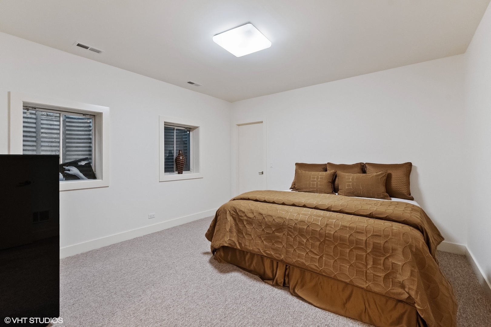 1632 Saunders Road Riverwoods, IL 60015 - Photo 33 of 38 a bedroom with a bed and two windows