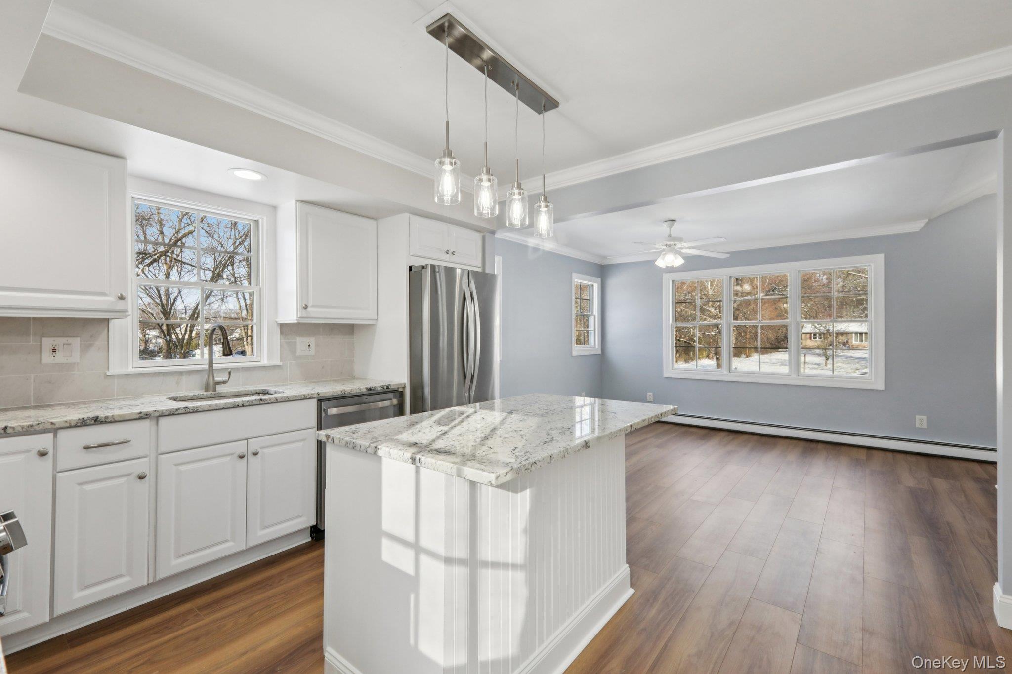 95 Smithtown Road Fishkill, NY 12524 - Photo 19 of 50 Kitchen featuring white cabinetry, stainless steel appliances, light quartzite counters, decorative light fixtures, and a kitchen island