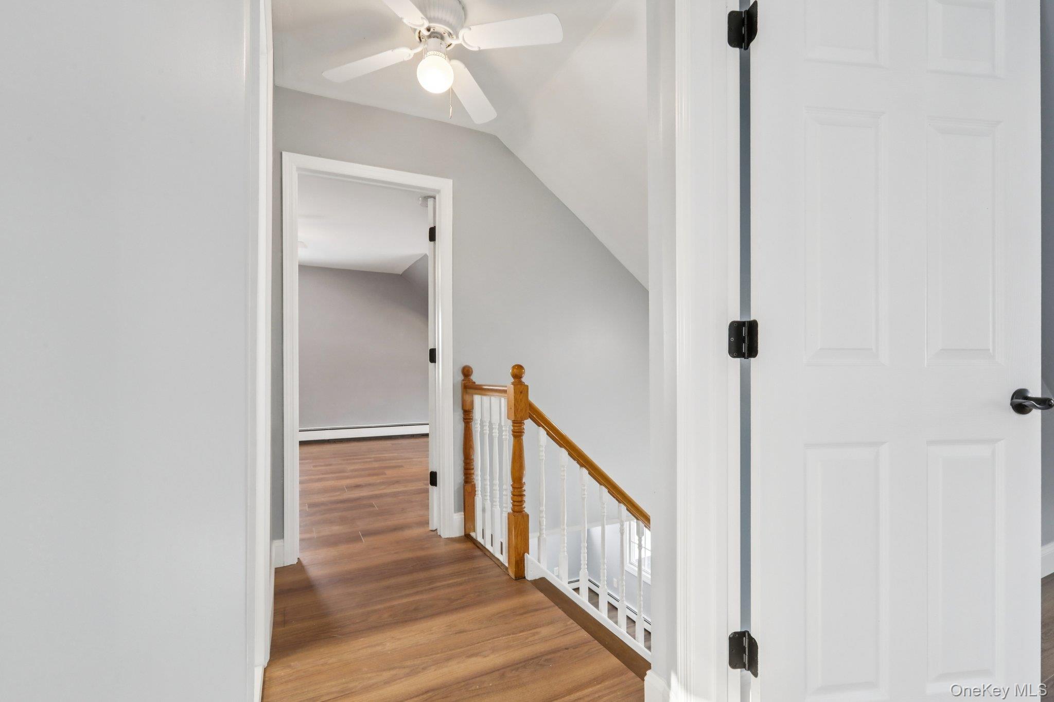 95 Smithtown Road Fishkill, NY 12524 - Photo 21 of 50 Hall with an upstairs landing, waterproof laminate floors, and a baseboard radiator