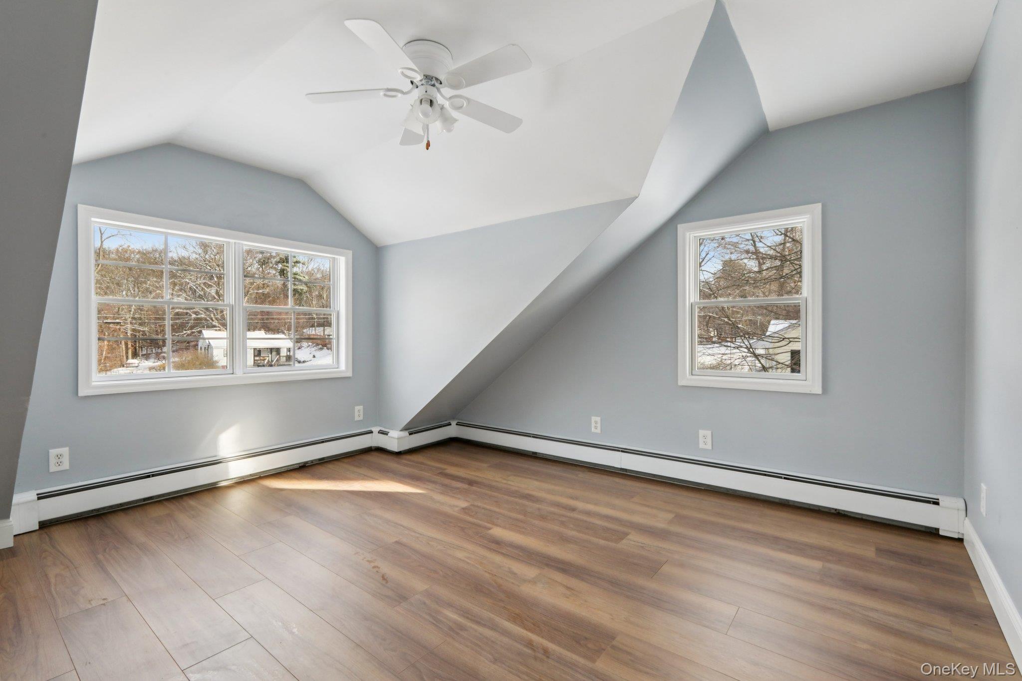 95 Smithtown Road Fishkill, NY 12524 - Photo 23 of 50 Bedroom 1 featuring a baseboard heating unit, lofted ceiling, waterproof laminate, and ceiling fan