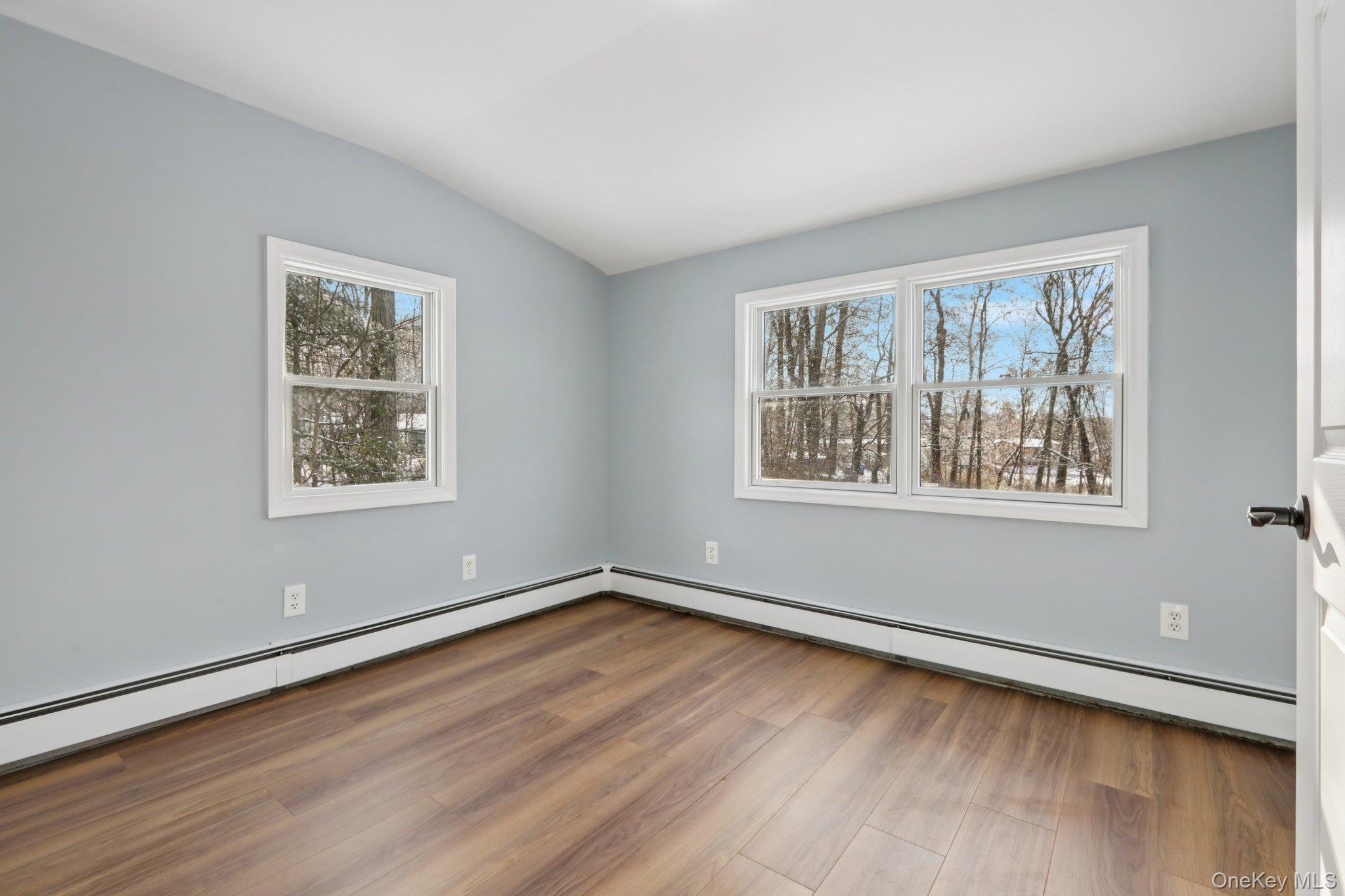 95 Smithtown Road Fishkill, NY 12524 - Photo 26 of 50 Bedroom 2 with baseboard heating, lofted ceiling, and waterproof laminate floors