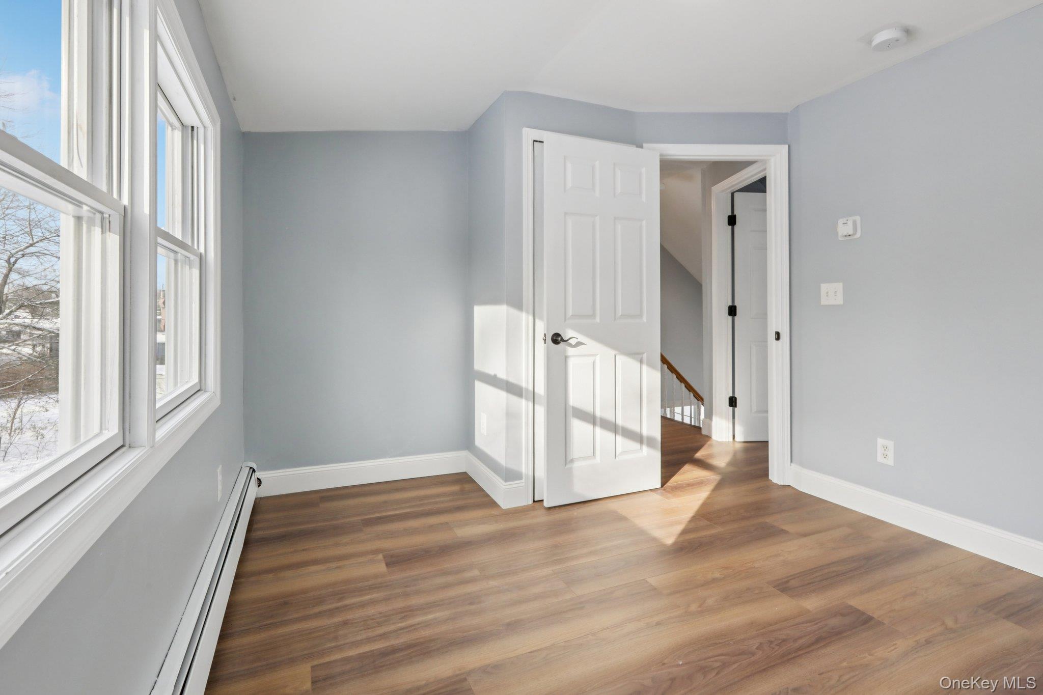 95 Smithtown Road Fishkill, NY 12524 - Photo 28 of 50 Bedroom 2 with a baseboard radiator and waterproof laminate floors