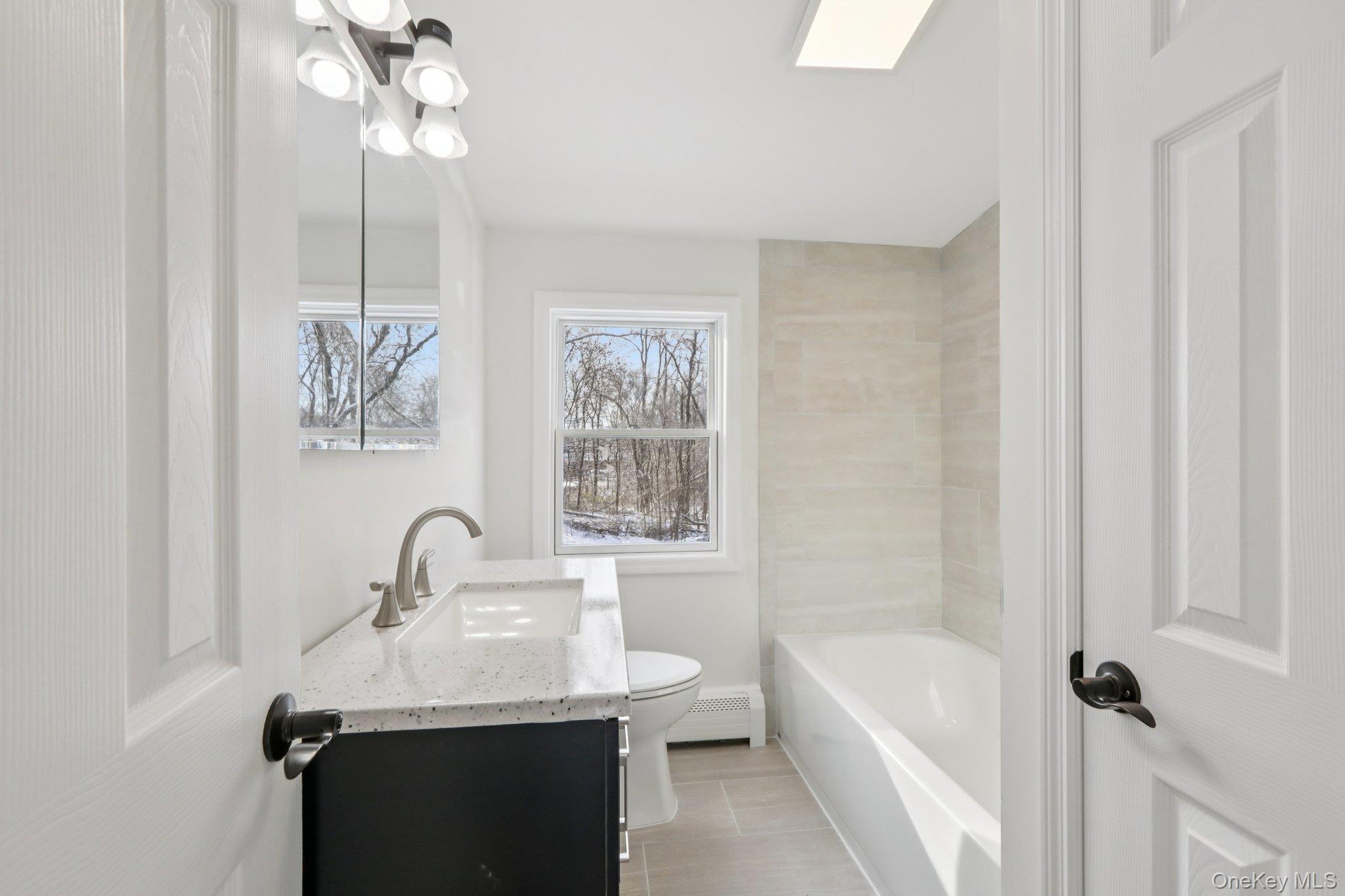 95 Smithtown Road Fishkill, NY 12524 - Photo 29 of 50 Full bathroom featuring vanity, a bathtub, and a baseboard radiator
