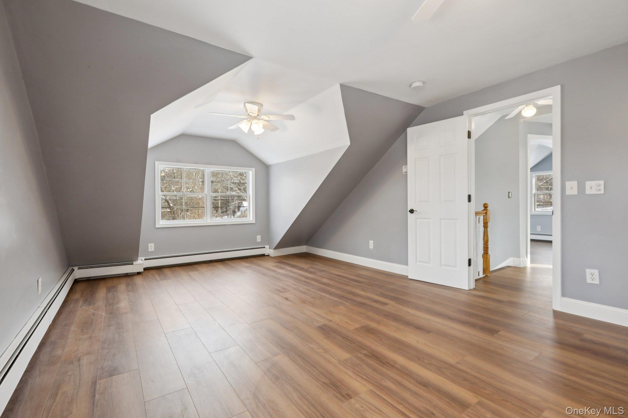 95 Smithtown Road Fishkill, NY 12524 - Photo 31 of 50 Primary Bedroom featuring a baseboard heating unit, ceiling fan, vaulted ceiling, and waterproof laminate floors