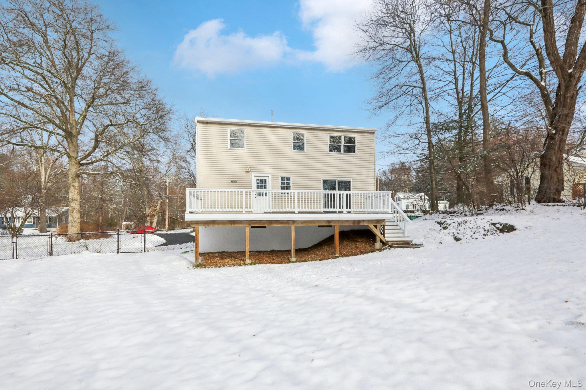 95 Smithtown Road Fishkill, NY 12524 - Photo 40 of 50 Snow covered house with a Trex deck, stairway, and a gate