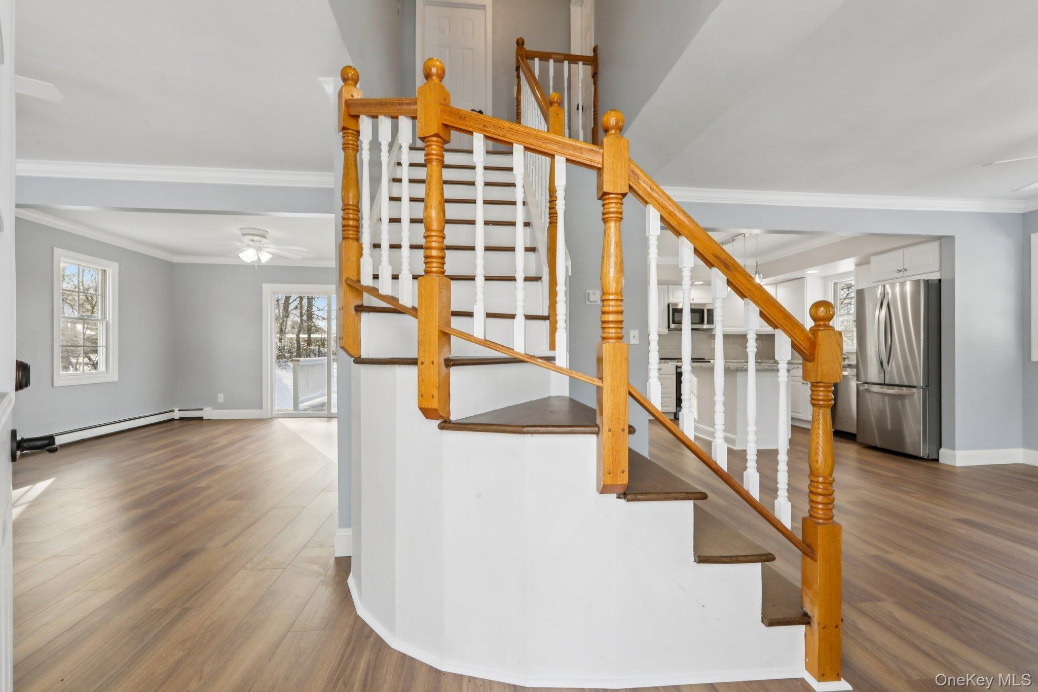 95 Smithtown Road Fishkill, NY 12524 - Photo 5 of 50 Stairs featuring crown molding, waterproof laminate floors, a ceiling fan, and baseboard heating