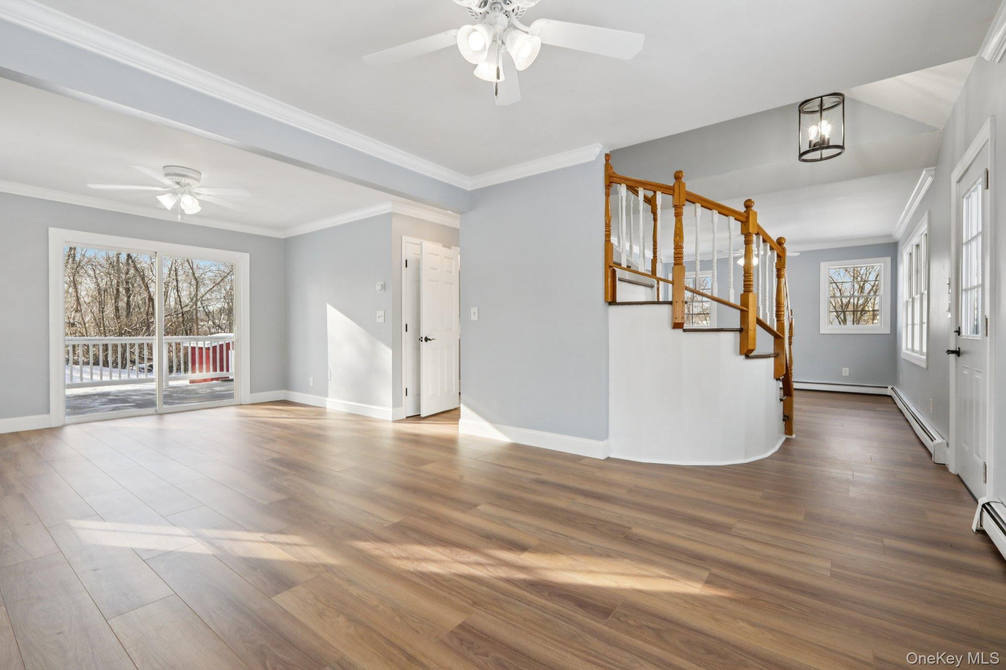 95 Smithtown Road Fishkill, NY 12524 - Photo 7 of 50 Entryway with ceiling fan, ornamental molding, waterproof laminate floors, and a baseboard radiator