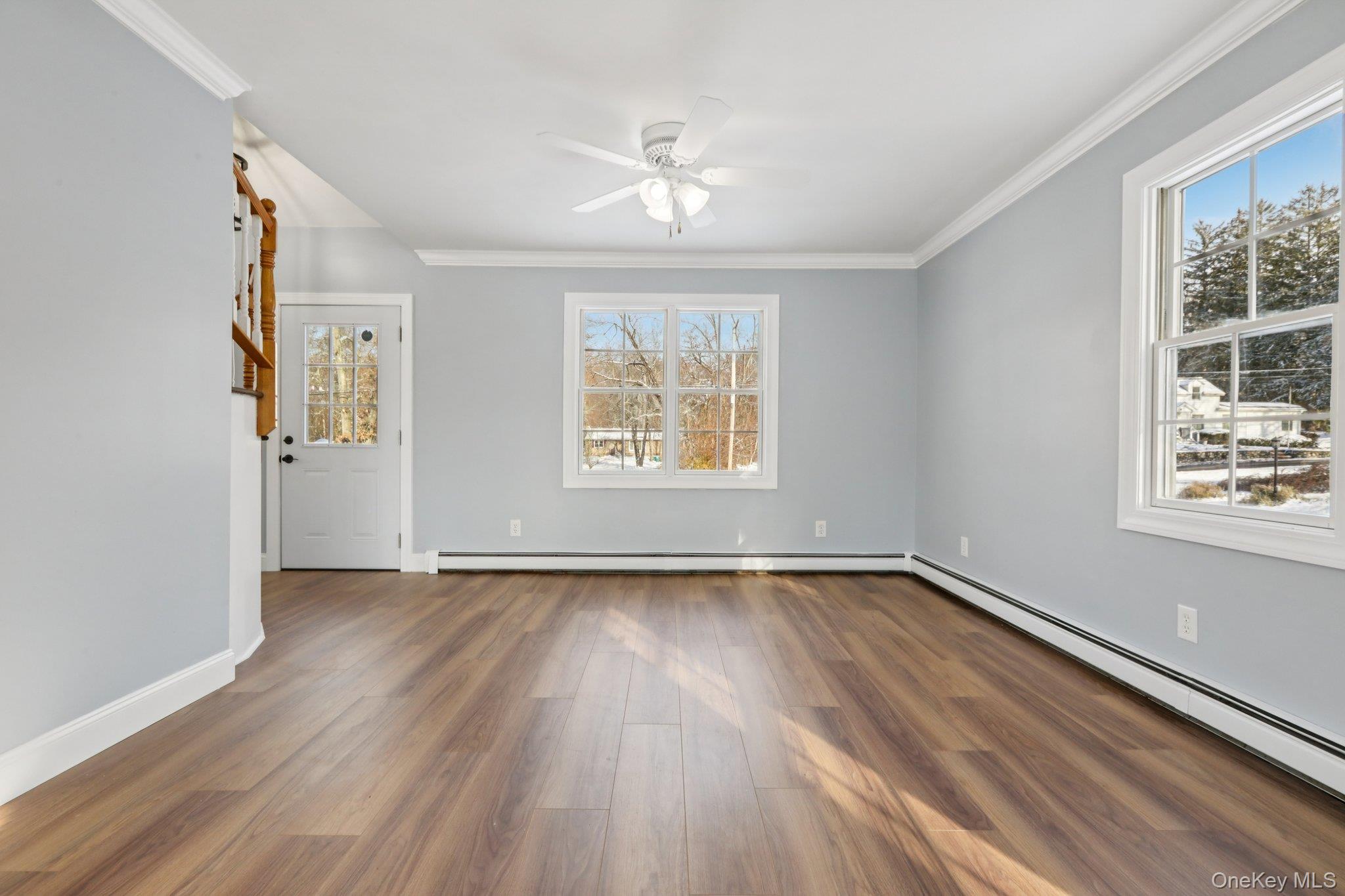 95 Smithtown Road Fishkill, NY 12524 - Photo 9 of 50 Crown molding, waterproof laminate floors, natural light, a baseboard heating unit, and ceiling fan