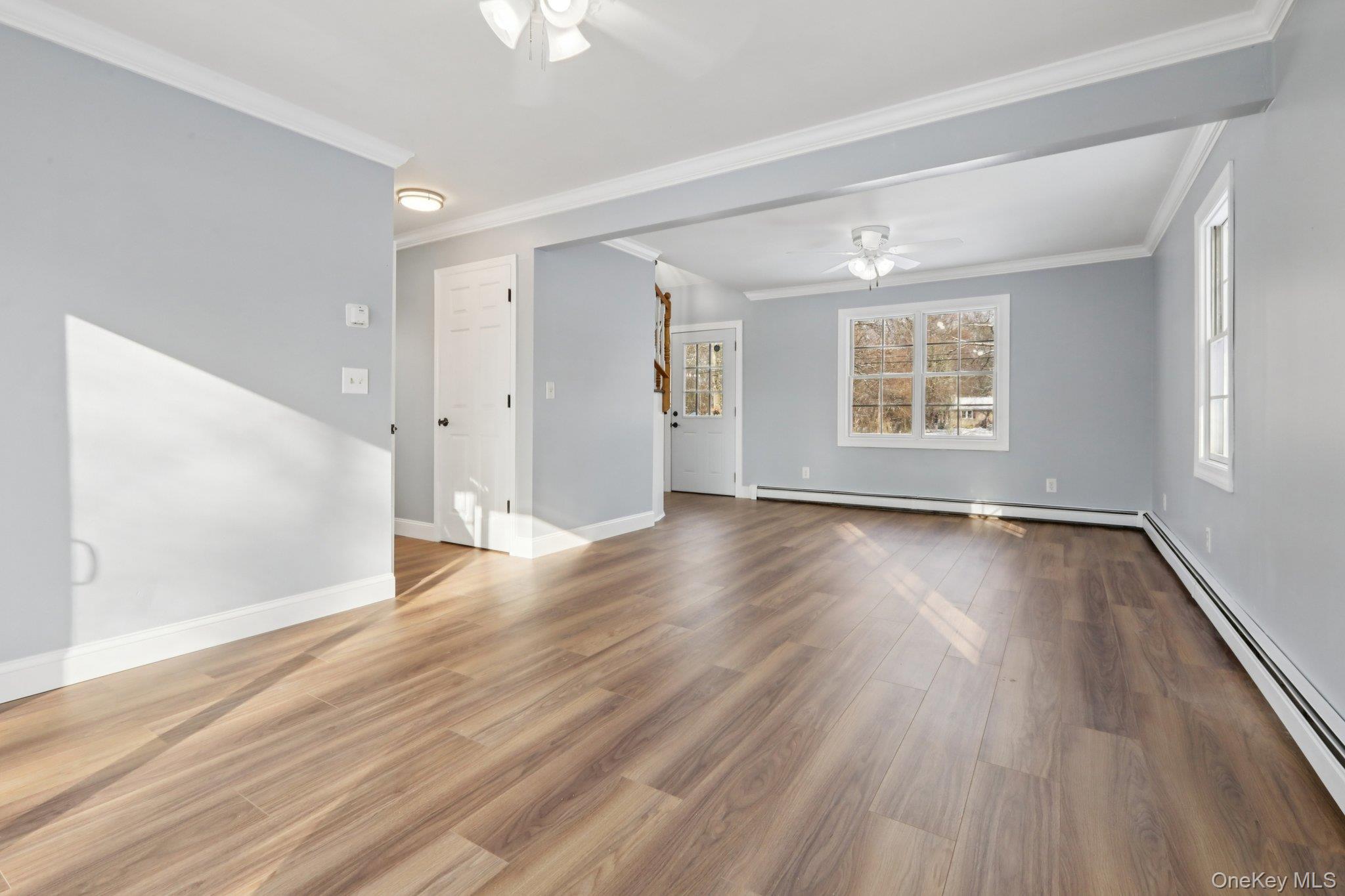 95 Smithtown Road Fishkill, NY 12524 - Photo 10 of 50 Ceiling fan, baseboard heating, waterproof laminate floors, and crown molding