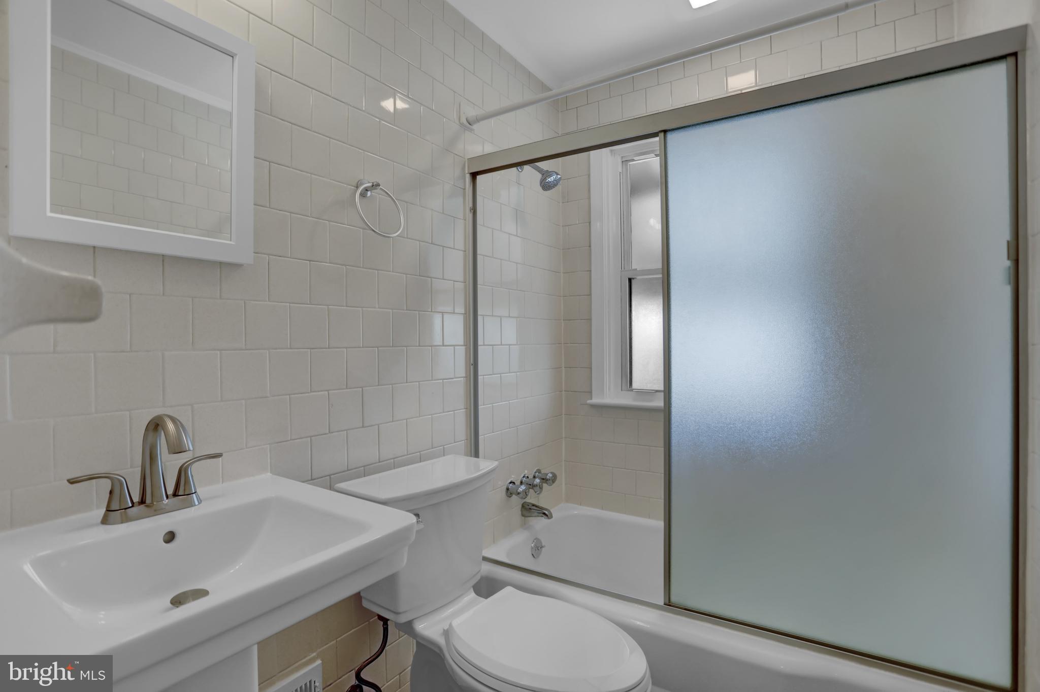 2857 Plainfield Road Baltimore, MD 21222 - Photo 12 of 38 a bathroom with a sink toilet and shower