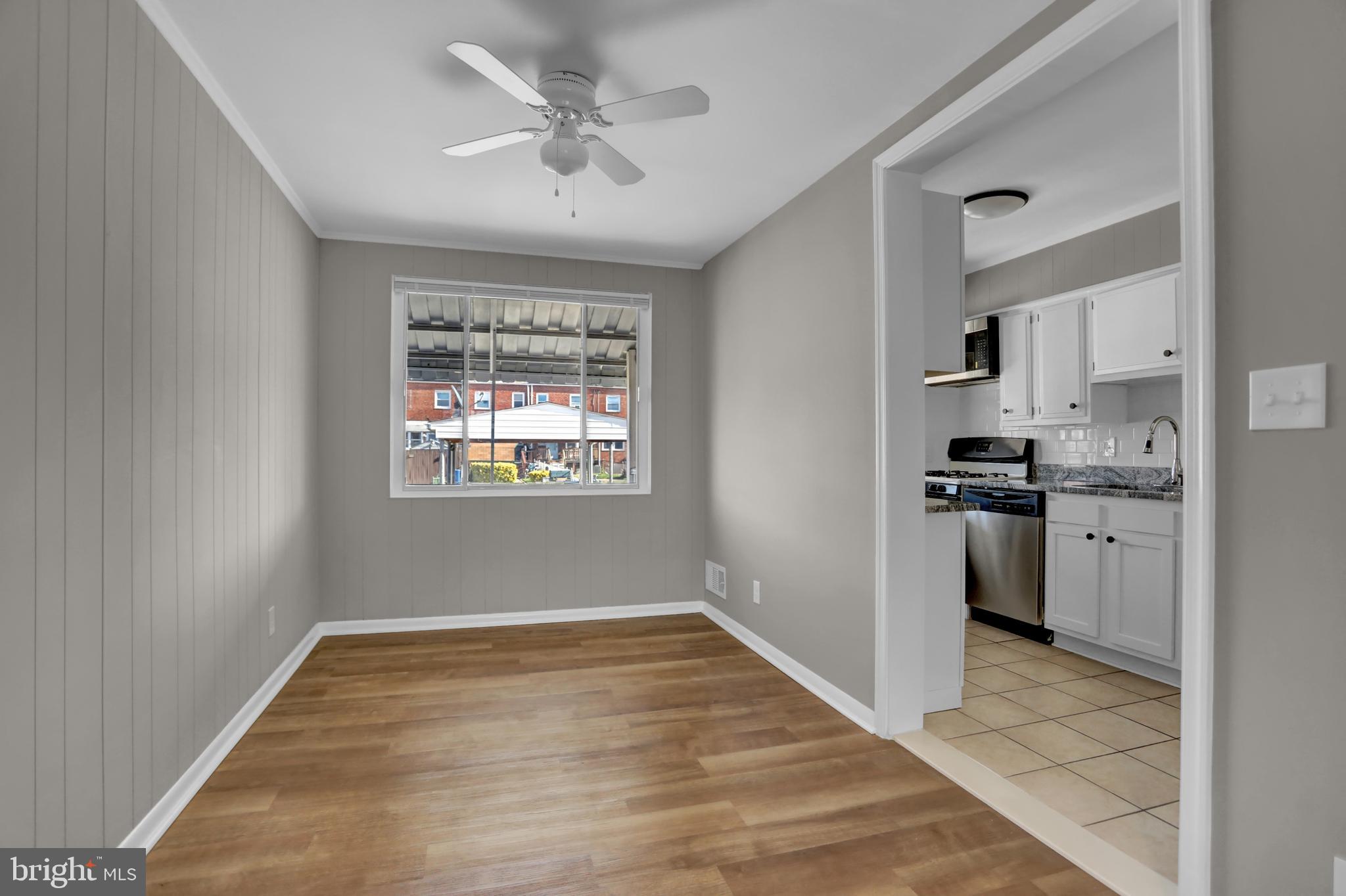 2857 Plainfield Road Baltimore, MD 21222 - Photo 18 of 38 a kitchen with granite countertop a refrigerator and a stove top oven