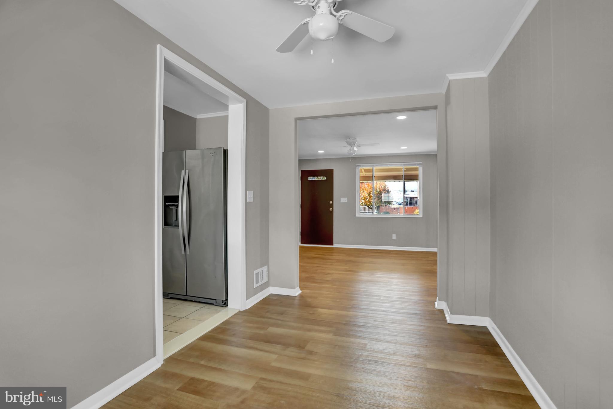 2857 Plainfield Road Baltimore, MD 21222 - Photo 19 of 38 wooden floor in an empty room with a window