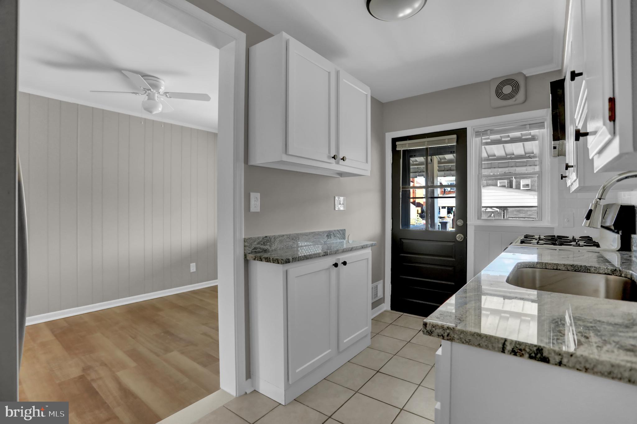 2857 Plainfield Road Baltimore, MD 21222 - Photo 20 of 38 a kitchen with granite countertop a refrigerator and a sink