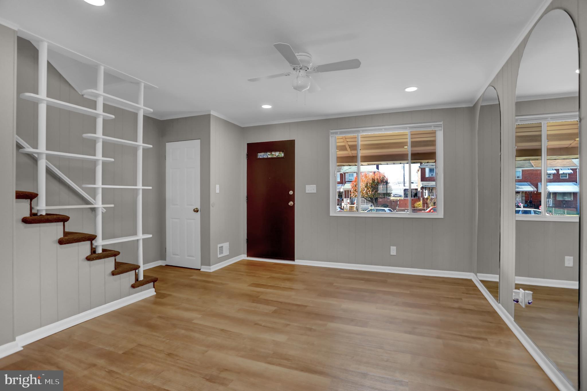 2857 Plainfield Road Baltimore, MD 21222 - Photo 2 of 38 an empty room with wooden floor and windows