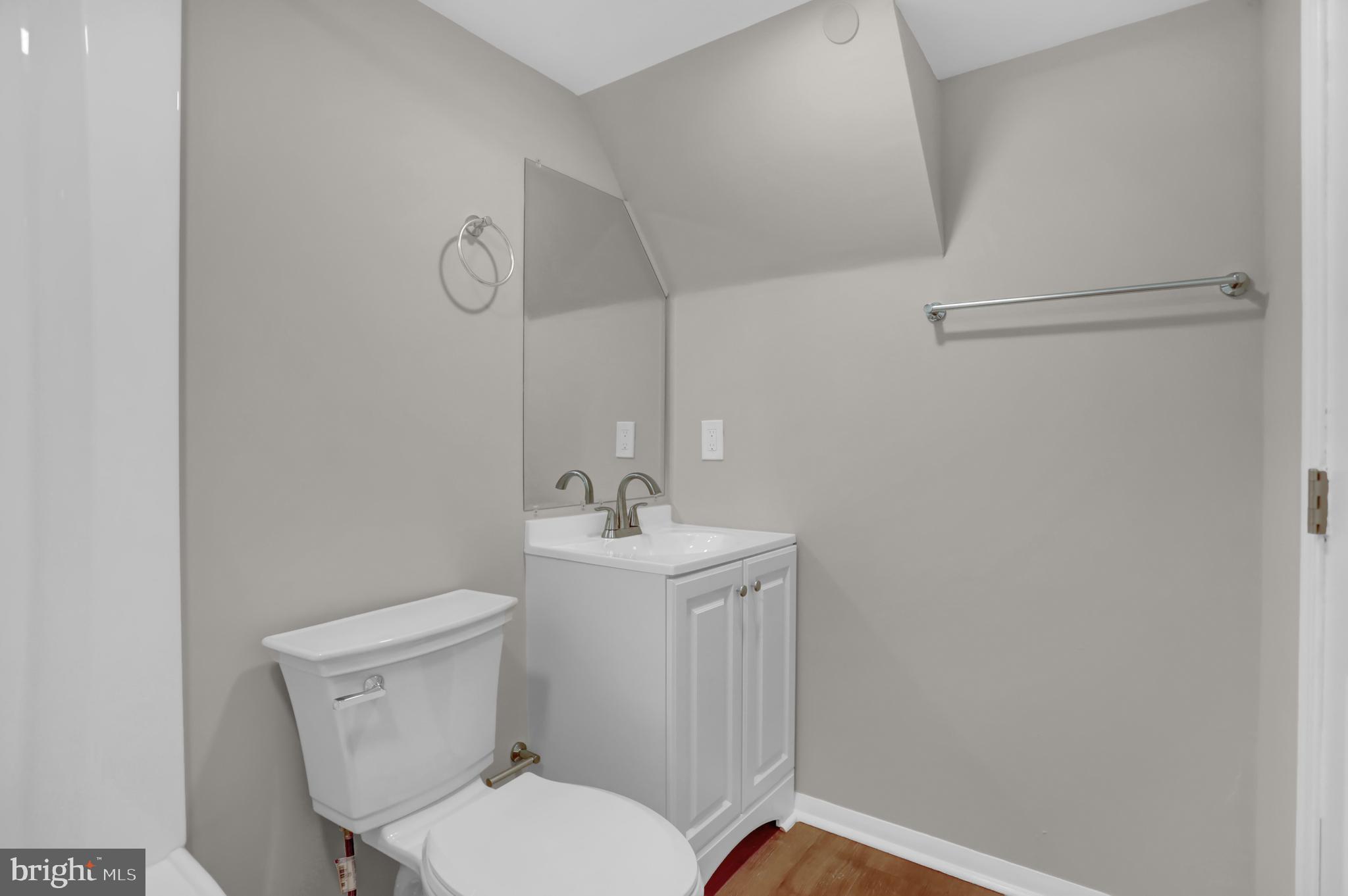 2857 Plainfield Road Baltimore, MD 21222 - Photo 23 of 38 a bathroom with a toilet sink and mirror