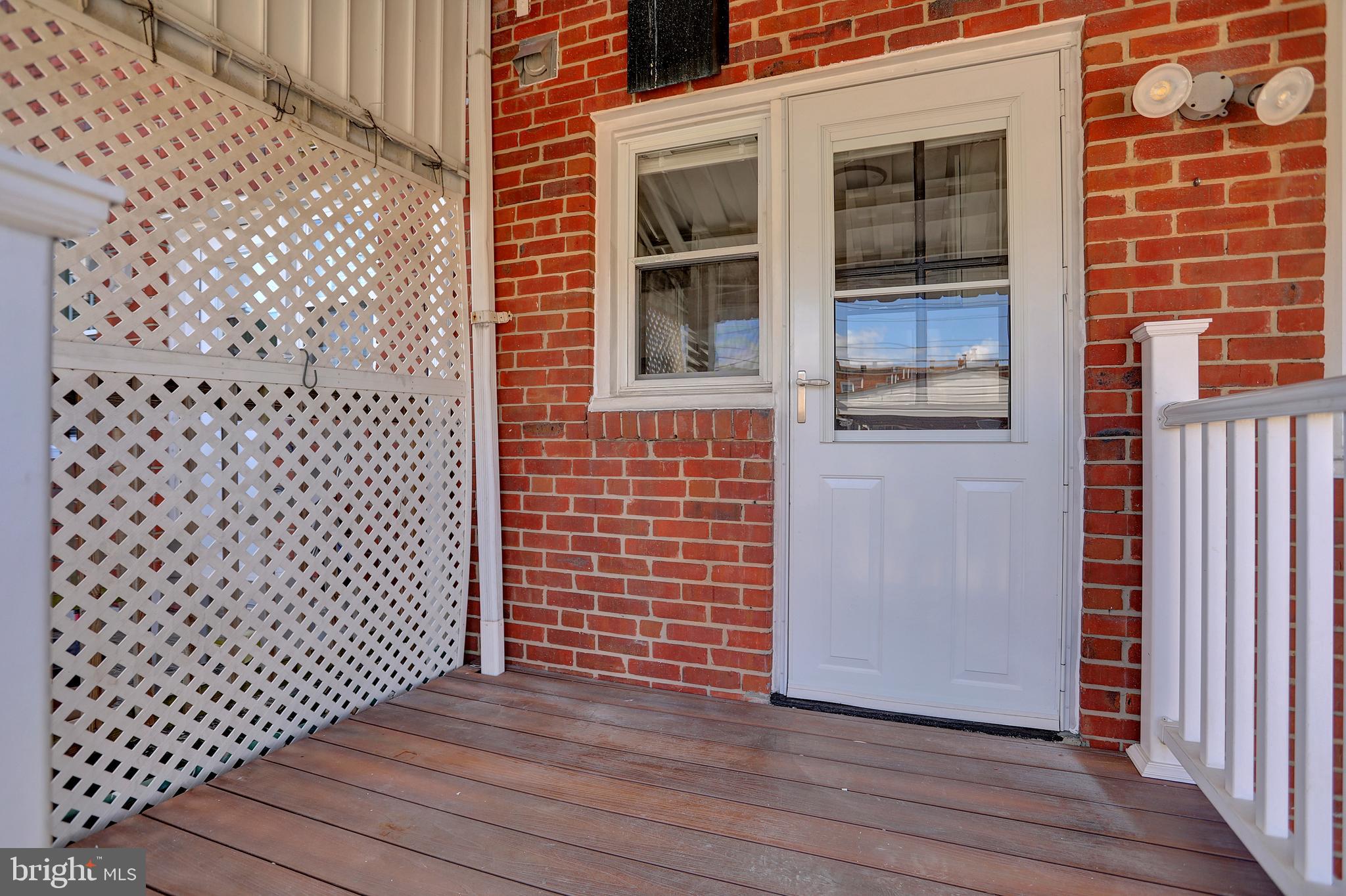 2857 Plainfield Road Baltimore, MD 21222 - Photo 26 of 38 a view of a brick house with wooden door