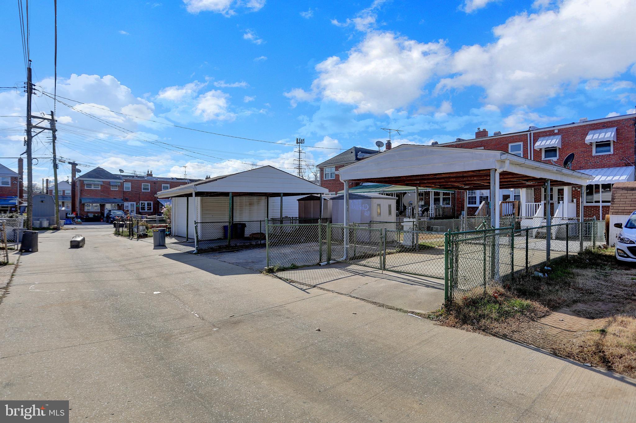 2857 Plainfield Road Baltimore, MD 21222 - Photo 31 of 38 a view of a white house with a yard plants and large tree