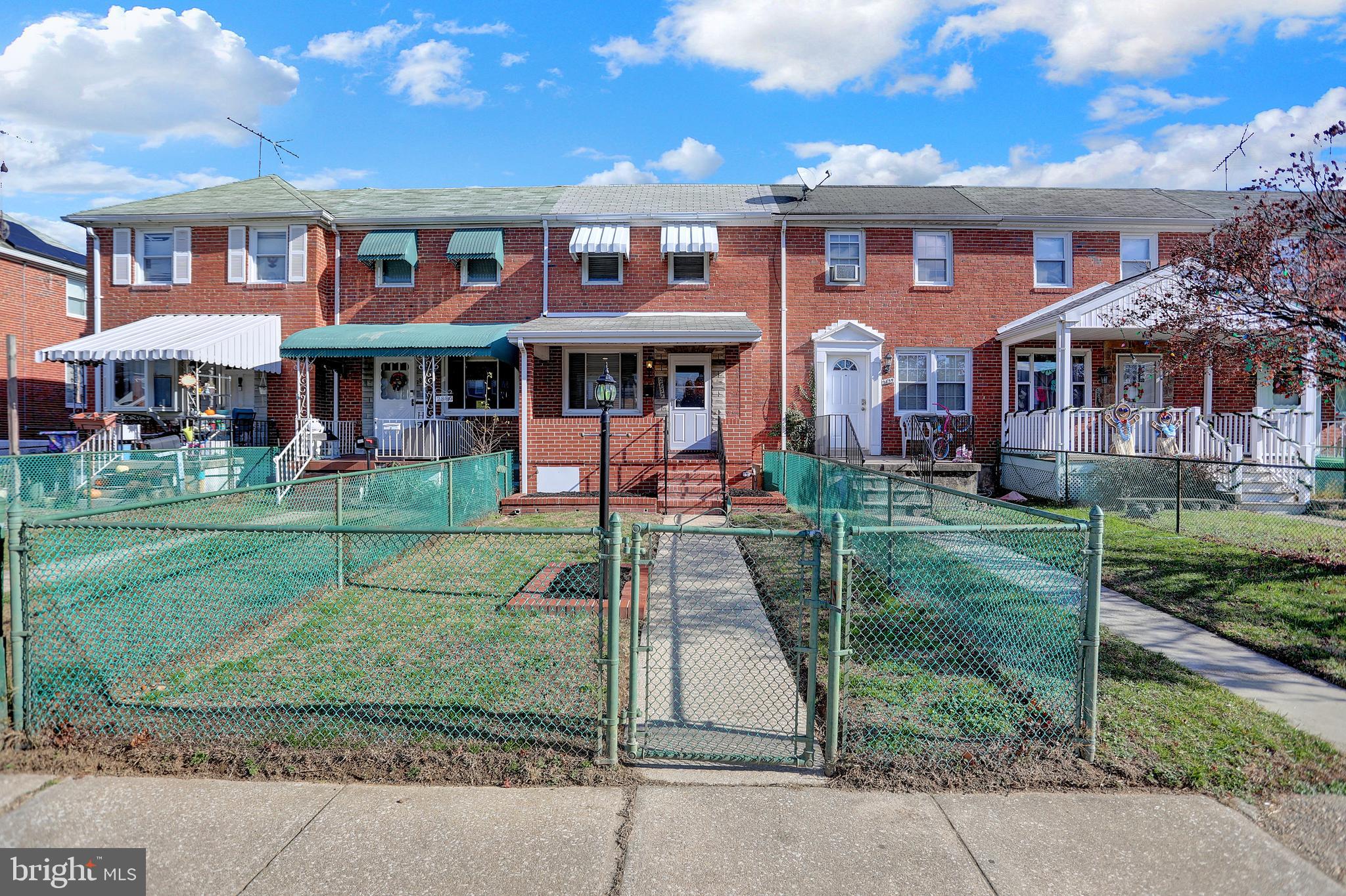 2857 Plainfield Road Baltimore, MD 21222 - Photo 33 of 38 front view of a brick house with a yard