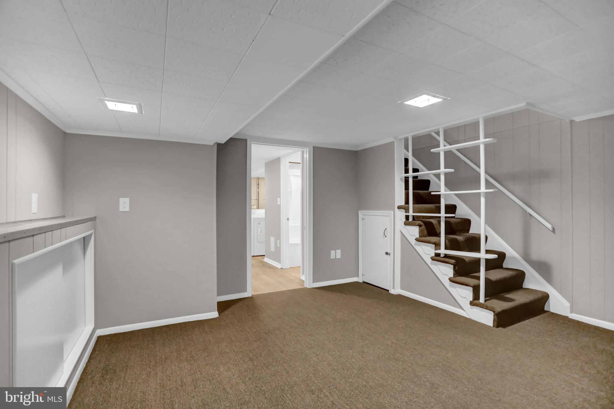 2857 Plainfield Road Baltimore, MD 21222 - Photo 6 of 38 an empty room with white walls and stairs