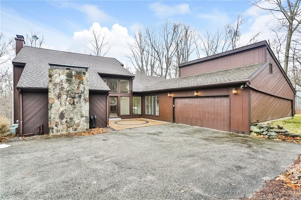 a view of a house with a garage and chair