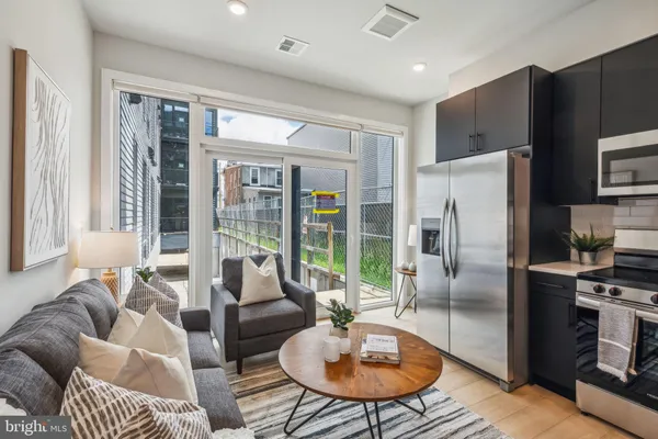 a living room with furniture a large window and a table