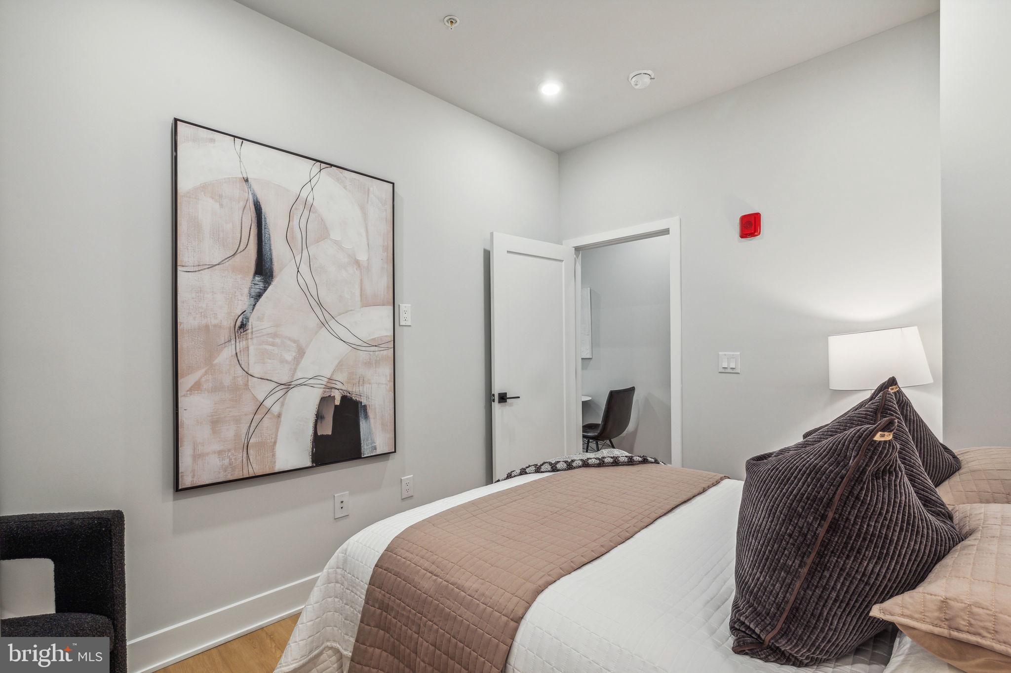 6910 Ridge Avenue, Unit 405 Philadelphia, PA 19128 - Photo 10 of 21 a bedroom with a bed and a window