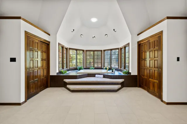 a spacious bedroom with a large bed and a large window