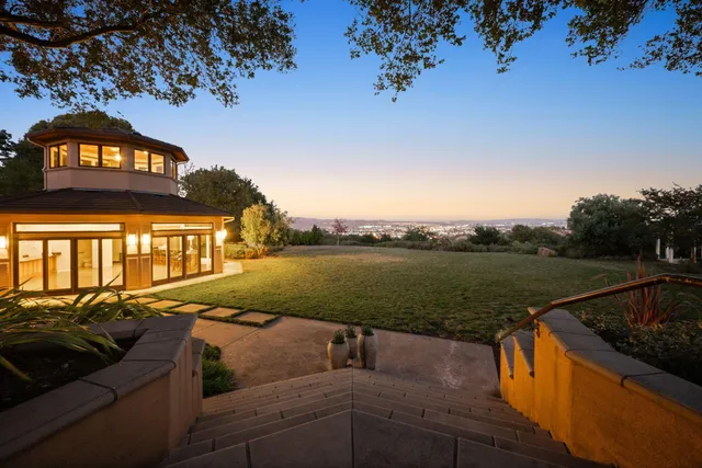a view of a lake with couches chairs