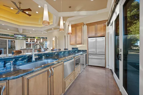 a large white kitchen with a large window