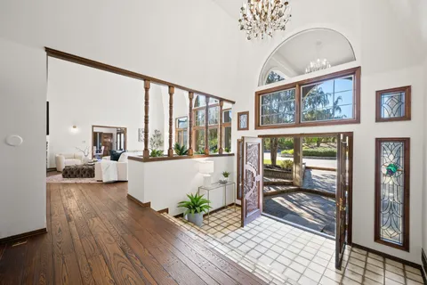 a living room with furniture and large windows