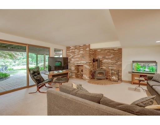 220 Old Littleton Road Harvard, MA 01451 - Photo 31 of 42 a living room with furniture floor to ceiling window and a flat screen tv