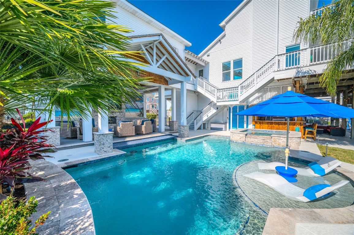 242 Isles End Road Tiki Island, TX 77554 - Photo 2 of 50 The 16,777-gallon pool and spa, built in 2019 by Rainey Pools, accommodates a volleyball net and feature a sun lounging deck with umbrella for shade and a full surround bench. Additional amenities include a poolside fresh water rinse shower and a two-zone mosquito misting system, ensuring comfort for outdoor entertaining throughout the seasons.