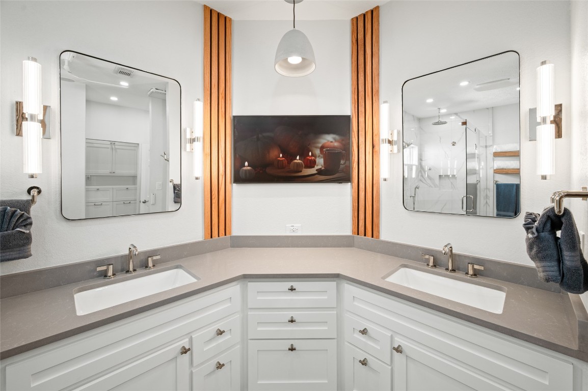 242 Isles End Road Tiki Island, TX 77554 - Photo 21 of 50 A closer look at the well thought out vanity space with the TV. Notice the amount of storage space underneath the sinks.