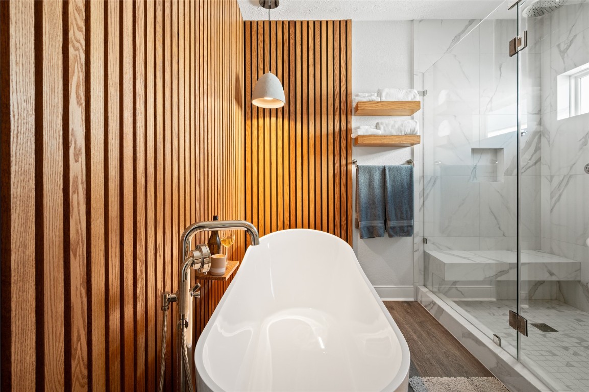 242 Isles End Road Tiki Island, TX 77554 - Photo 22 of 50 Relaxation heaven! This soaking tub is the perfect way to wind down after a day in the sunshine! Adjacent to the tub sits a wooden ledge, where candles and beverages can be placed.