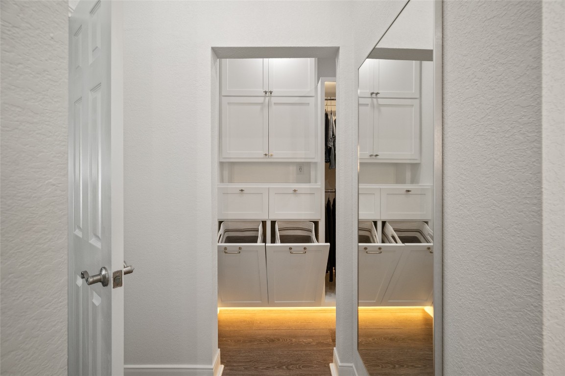 242 Isles End Road Tiki Island, TX 77554 - Photo 24 of 50 Another angle of the newly renovated closet, featuring two built-in laundry hampers and built-in drawers.