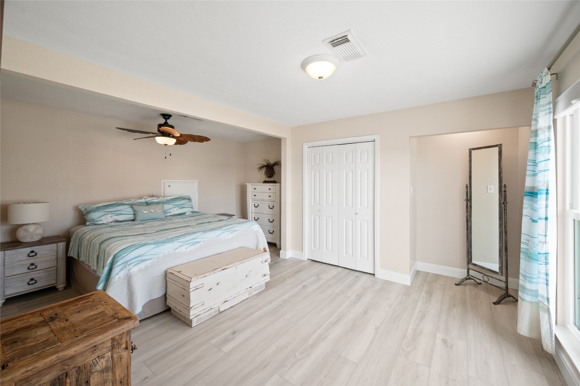 242 Isles End Road Tiki Island, TX 77554 - Photo 25 of 50 Upstairs greets you with two large secondary bedrooms, each having their own closet and perfect view of the canal.