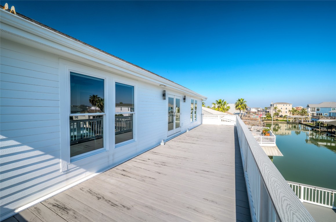 242 Isles End Road Tiki Island, TX 77554 - Photo 30 of 50 Second floor deck overlooking the lower deck and glistening canal.