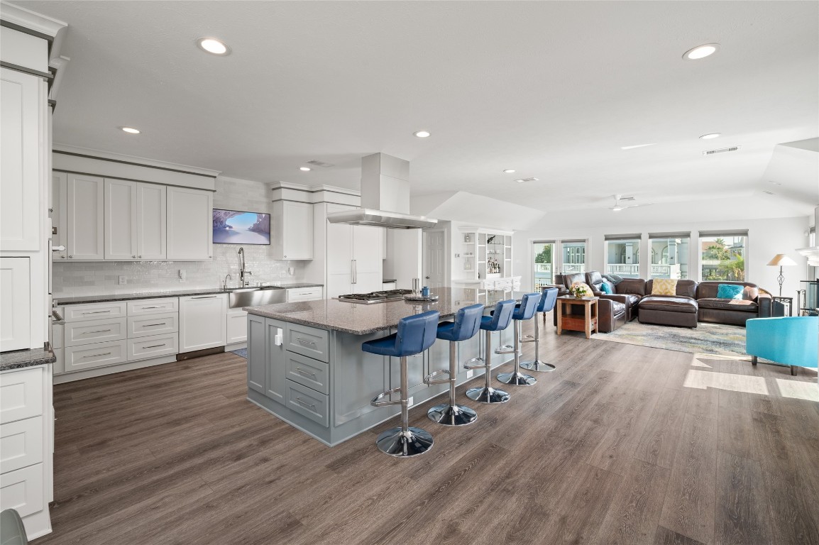 242 Isles End Road Tiki Island, TX 77554 - Photo 3 of 50 The chef’s island kitchen features an oversized island with range and breakfast bar seating for five. Specialty Thermador appliances include stainless steel double refrigerators, built-in freezer, wine refrigerator, convection, microwave, and steam ovens. A spacious walk-in pantry and cleverly designed storage throughout enhance both everyday living and large-scale entertaining.