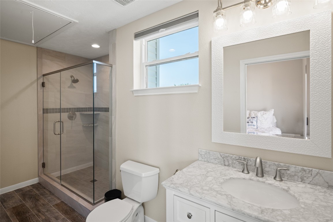 242 Isles End Road Tiki Island, TX 77554 - Photo 32 of 50 One of the secondary bathrooms features marble countertops and a standing glass shower.