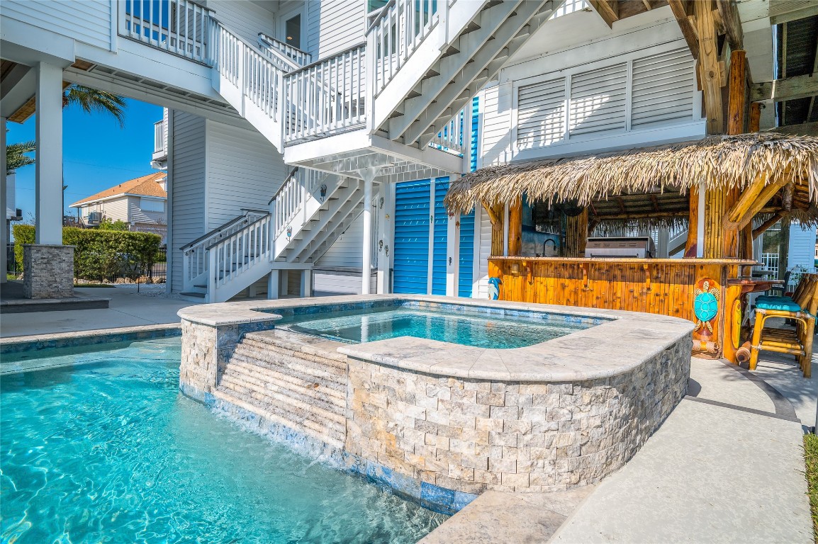 242 Isles End Road Tiki Island, TX 77554 - Photo 39 of 50 The Spa provides bench seating and a water feature. The Tiki Bar is conveniently close by.