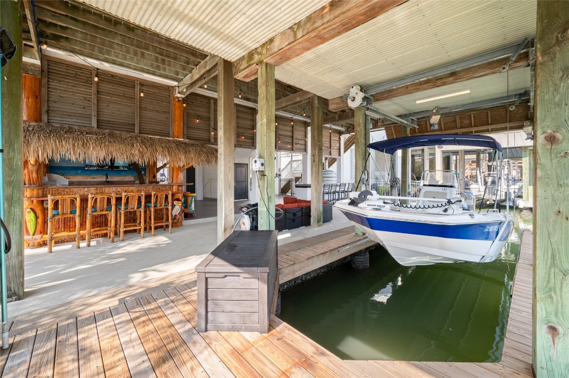242 Isles End Road Tiki Island, TX 77554 - Photo 40 of 50 The boathouse includes a powered boat lift and easy access to West Galveston Bay. Green underwater fishing lights illuminate the canal in the evenings, making this an ideal setting for fishing and waterfront enjoyment.