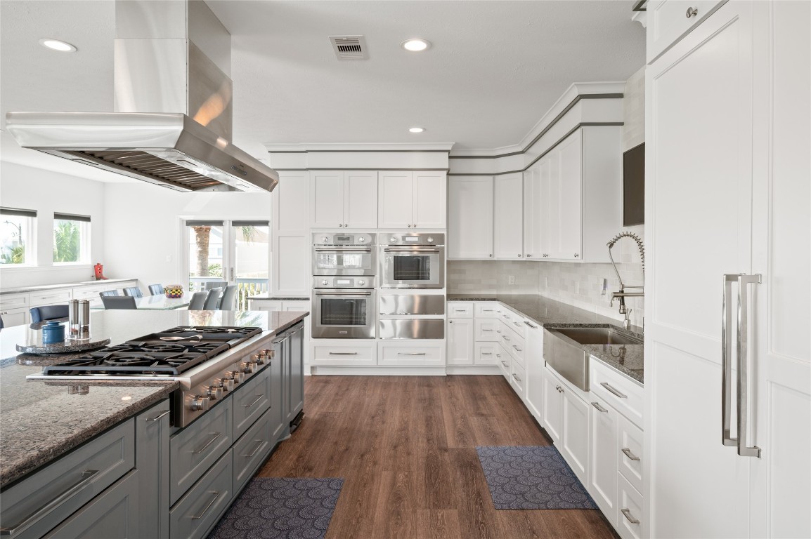 242 Isles End Road Tiki Island, TX 77554 - Photo 4 of 50 This angle of the kitchen highlights the Thermador appliances, handsome floors, and abundant space for meal prep and entertaining with the dining areas beyond. After all, the kitchen is the heart of the home!