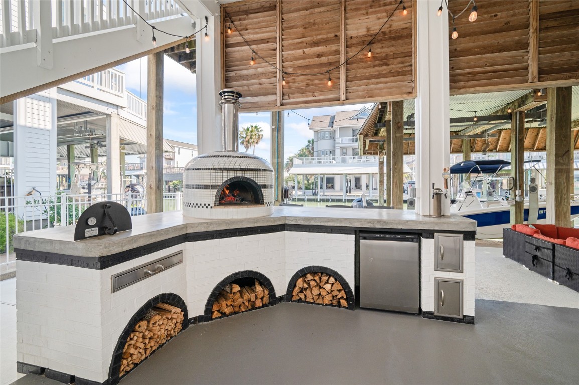 242 Isles End Road Tiki Island, TX 77554 - Photo 44 of 50 This decorative, Forno wood- fired pizza oven and pizza bar give you plenty of counter space for creating your own slices of heaven! The kegerator adds a nice touch to this culinary corner. Note the storage cabinets and drawer. The custom stools convey with the property.