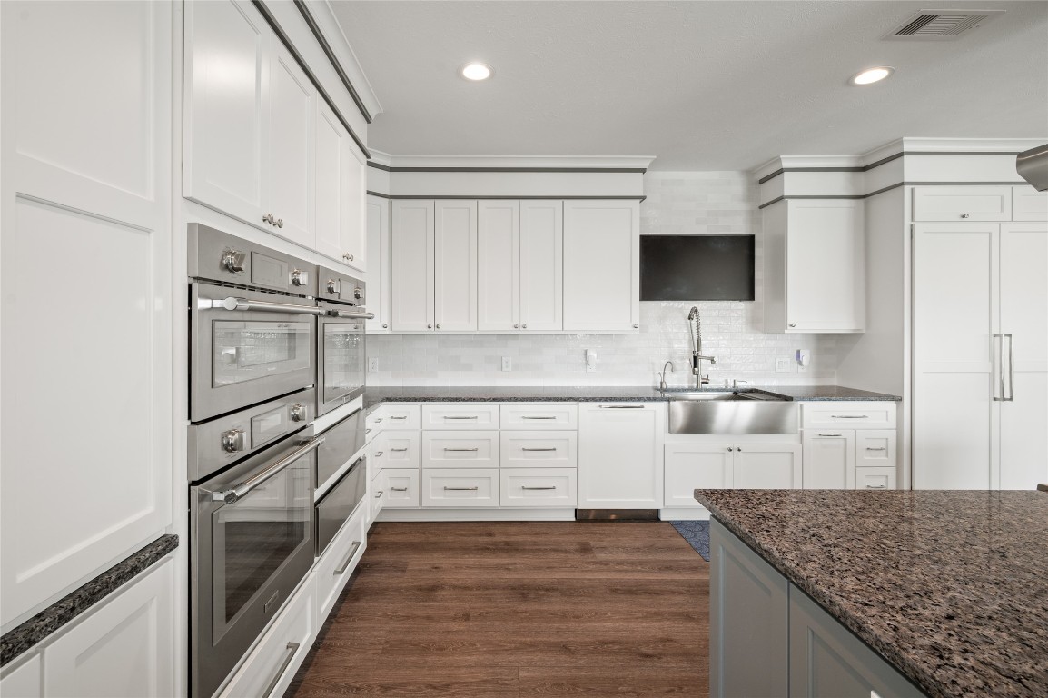 242 Isles End Road Tiki Island, TX 77554 - Photo 5 of 50 This angle of the kitchen highlights the Thermador appliances, handsome and durable vinyl- plank flooring, and abundant space for meal prep and entertaining with the dining areas beyond. After all, the kitchen is the heart of the home!